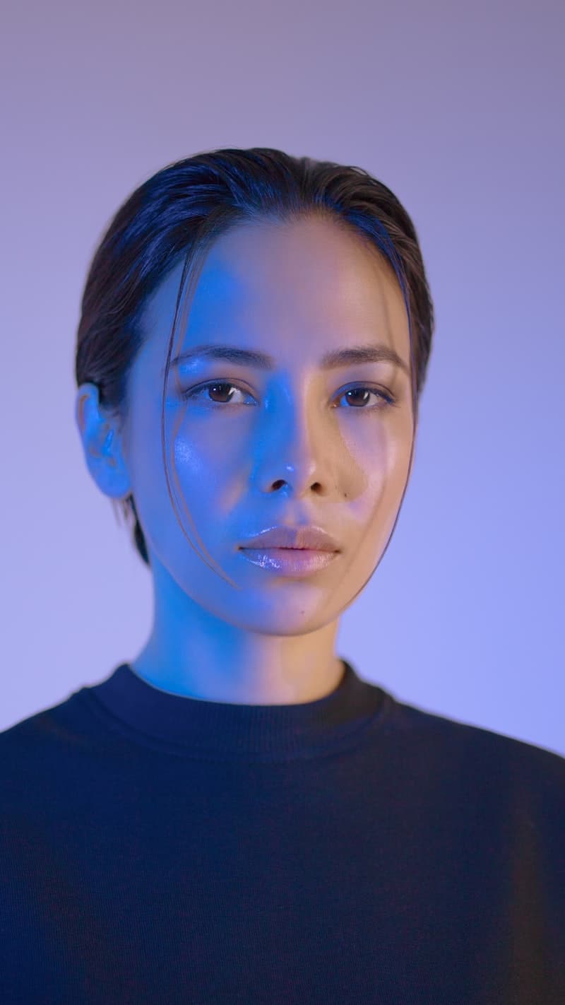Creator on a dark background looking into the lens
